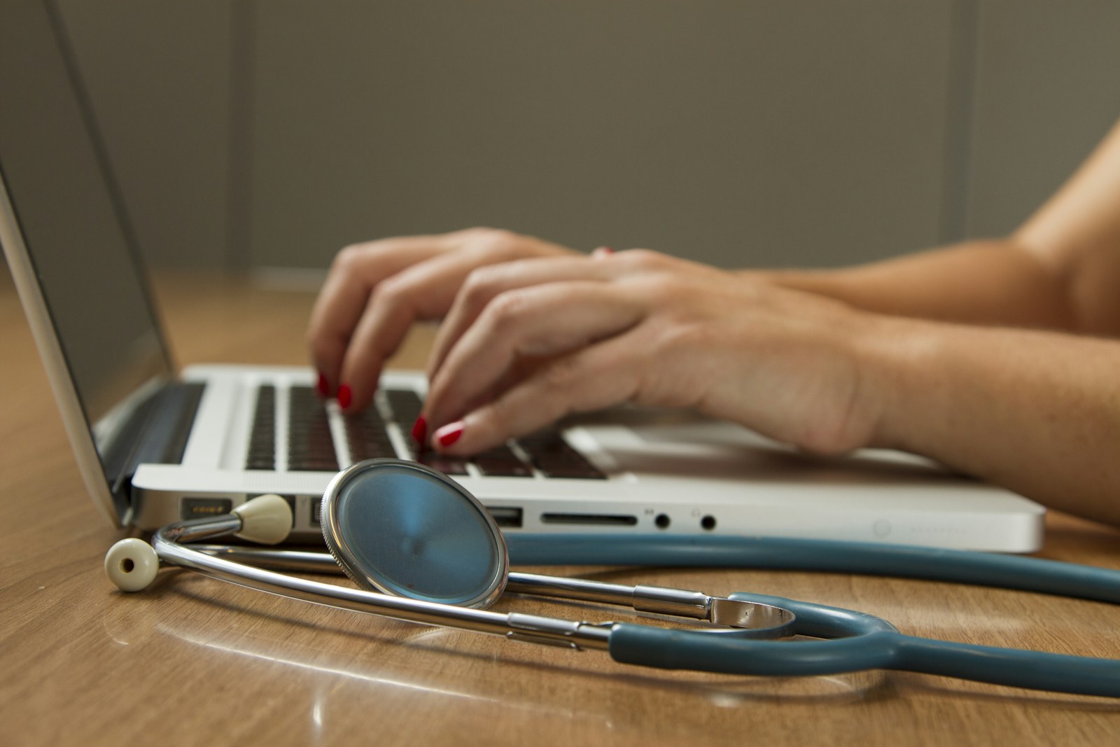 Medical coding audit workstation with laptop and stethoscope